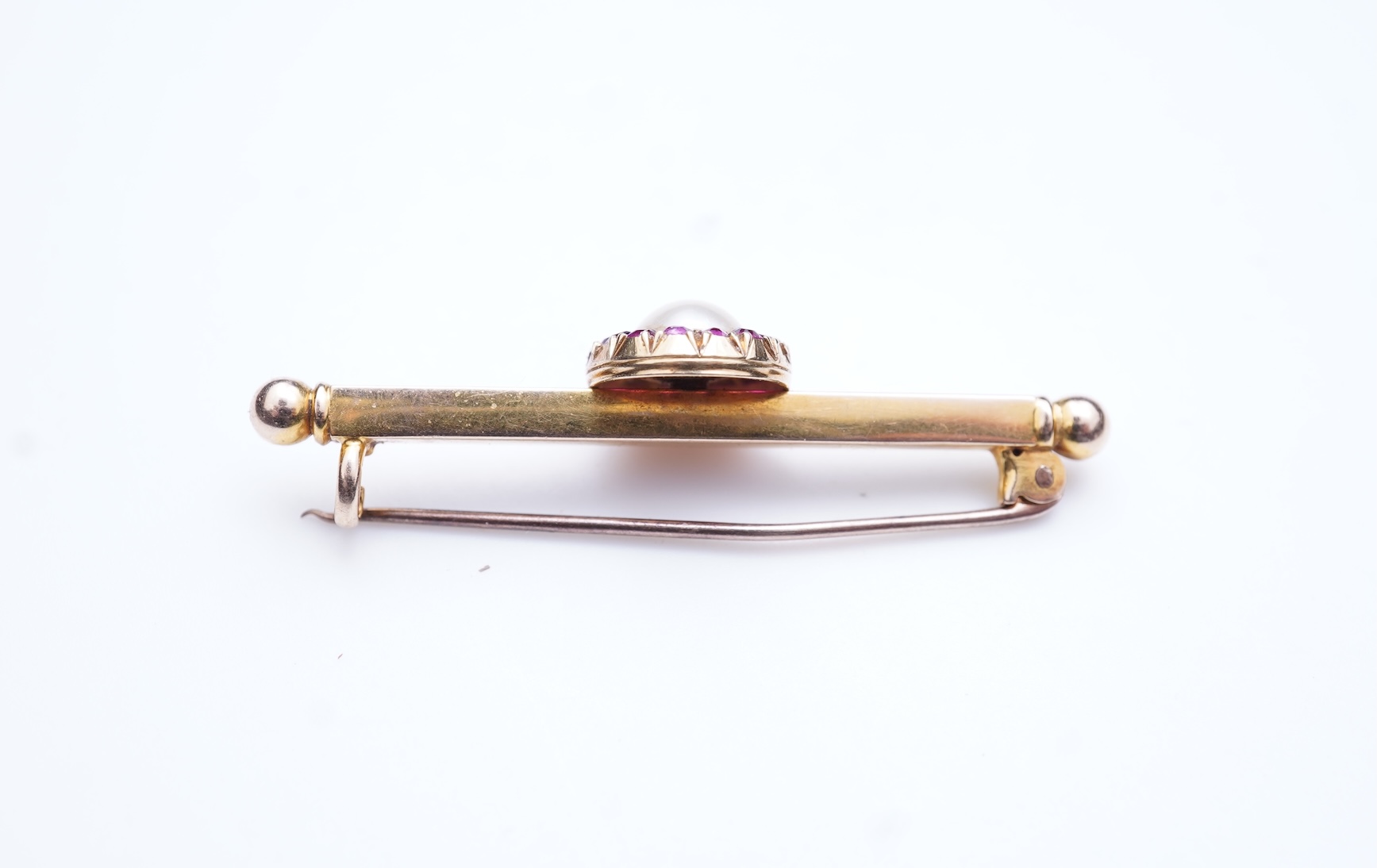 A pearl and ruby bar brooch, 19th century